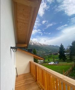 a balcony of a house with a view of a mountain at Casa Marta Dolomiti in Vigo di Fassa