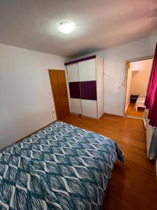 a bedroom with a bed and a room with a window at Apartments Gojević in Crikvenica