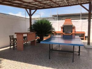 - une table de ping-pong bleue sur la terrasse dans l'établissement Casa en Ballenita: Piscina, Vóley, BBQ y Mar Cerca, à Ballenita