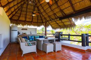 an outdoor living room with a table and chairs at Villa Monte in Sayulita