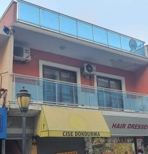 a building with a balcony on top of it at sea and mountain view roof terrace central in Alanya