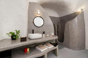 a bathroom with a sink and a mirror on a counter at 1812 Caves 'n Mansion in Karterados