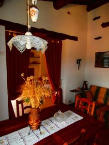 a dining room table with a vase of flowers on it at Casa Bacci in Siena