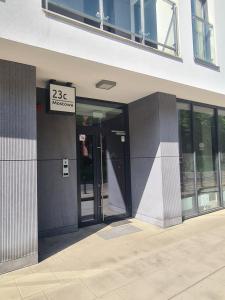 an entrance to a building with a sign on it at Mostowa 23 BRUNO Apartment, self check-in 24h, free parking, air-conditioning in Poznań