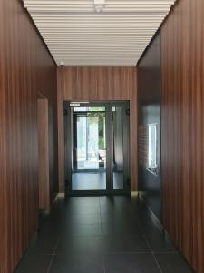 an empty hallway with wooden walls and a door at Mostowa 23 BRUNO Apartment, self check-in 24h, free parking, air-conditioning in Poznań +40 photos