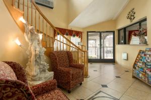 a living room with a staircase and a chair at Triplodge of Santa Clarita in Santa Clarita