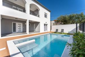 a swimming pool in the backyard of a house at Bernie apartments with a pool in Zadar