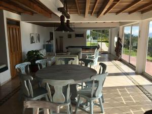 a dining room with a table and chairs at La Casa de la Montaña in La Vega