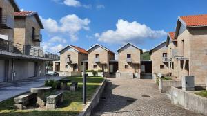a row of houses in a row at Villas do Laboreiro - Casa 8 in Castro Laboreiro