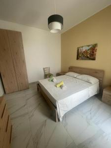 a bedroom with a large bed in a room at Camere Lorenzo in Porto Cesareo