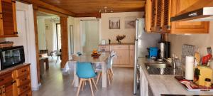 a kitchen with a counter and a table with chairs at Au chalet d'Anna in Saint-Rambert-en-Bugey