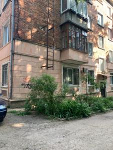 a brick building with a balcony on the side of it at VEL ЛЮКС in Chernivtsi