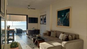 a living room with a couch and a table at Loutraki Bay in Loutraki