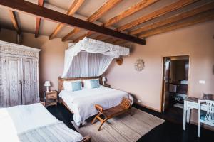 a bedroom with a large white bed and a chair at Villa Del Sol in Máncora