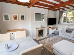 a living room with a table and a fireplace at Wayland House in Bakewell