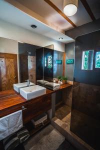 a bathroom with a sink and a mirror at Villa Del Sol in Máncora