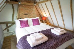 sypialnia z łóżkiem z dwoma ręcznikami w obiekcie The Cottage, High Ash Farm w mieście Peasenhall