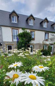 a house with white flowers in front of it at Gite NATURALLY CALM in Montbray