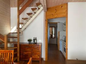 a kitchen with a wooden staircase in a house at Casa Anna in Vesta
