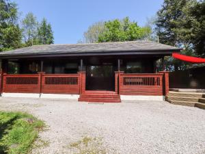 a house with a red frisbee in front of it at Gisburn Forest Lodge in Skipton