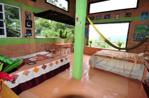 a room with two beds and a hammock in it at Ecobiosfera in Catemaco