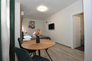 a living room with a table and a bed at SOFIA'S Studio & Room in Zadar