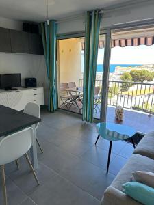 a living room with a couch and a table at Appartement Miramar in Banyuls-sur-Mer