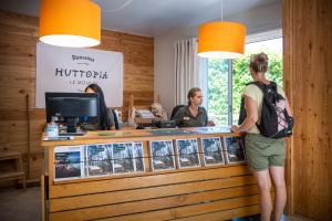 圣马丁阿尔代什Huttopia Le Moulin的两个女人站在票房柜台的户夫达商店