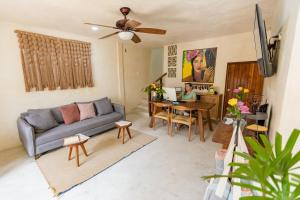 a living room with a couch and a table at Hotel Siesta Holbox in Holbox Island