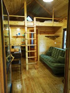 a living room with a couch and a bunk bed at Bakasana in Ruciane-Nida