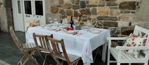 a table with a white table cloth on top of it at Hotel Rural El Secreto de Julia in Ríoseco