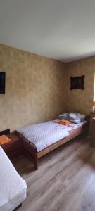 a bedroom with a bed and a wooden floor at Apartamenty z ogrodem nr 3 z tarasem in Mrągowo