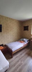 a bedroom with a bed and a wooden floor at Apartamenty z ogrodem nr 3 studio z tarasem in Mrągowo