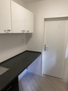 a kitchen with a desk and a door at Ferienwohnung in Bad Segeberg in Bad Segeberg