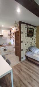 a small kitchen with a bed in a room at Apartamenty z ogrodem nr 3 studio z tarasem in Mrągowo +10 photos