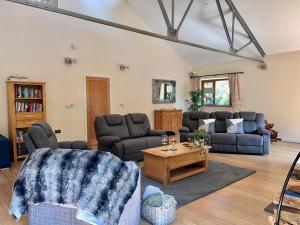 a living room with two couches and a coffee table at Pass the Keys Perfect Tranquil Holiday Home Old Forge Pumphouse in Kidwelly