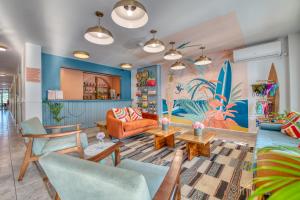 a living room with a couch and chairs at Bocas Paradise Hotel in Bocas del Toro