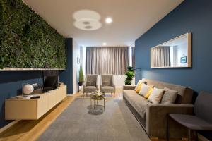 ein Wohnzimmer mit einem Sofa und einem TV in der Unterkunft Abbey Apartments City Center in Porto