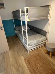 a bunk bed with a ladder in a room at Quinta da Layla in Olhão