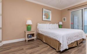 a bedroom with a bed and a large window at Island Royale 1103 condo in Gulf Shores