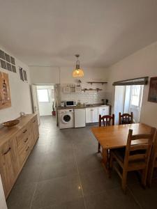a kitchen with a table and a dining room at Apartment in old town with roof terrace and fibre, Tarifa in Tarifa