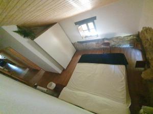 a room with a bed in the middle of a room at Casa Rural Angostina in Carcabal