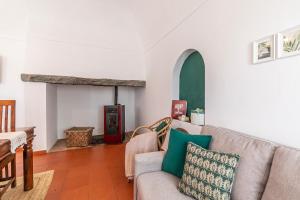 a living room with a couch and a fireplace at Herdade das Castas Nobres in Redondo