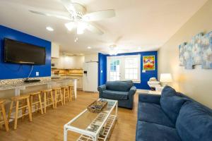 a living room with a couch and a table at BachelorPARTY HQ for 16-Feet to Duval-Pool-Hot tub in Key West
