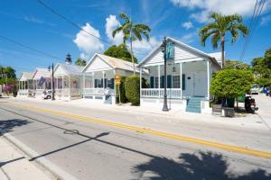 a row of houses on a street in a town at Just steps to Duval- Sleeps 10- Heated Pool House in Key West
