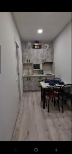 a living room with a table and a kitchen at Apartments - Viva Ukraine in Uzhhorod