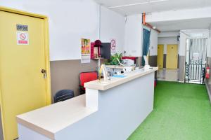a room with a counter and a green floor at T FAMILY HOTEL in Klang