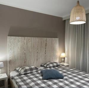 a bedroom with a checkered bed with two pillows at Agroturystyka BM Horse in Tągowie
