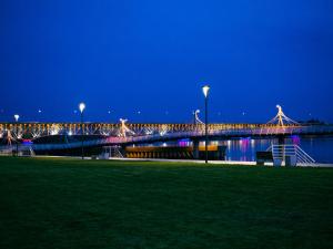 a bridge over the water at night with lights at Best Choice 2-bedroom Apartment in Płock