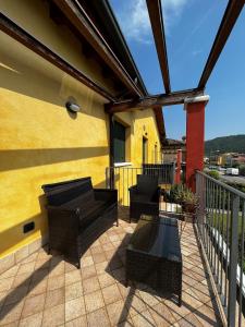 a patio with two chairs and a fence at Apartment-Rosella Garda in Garda